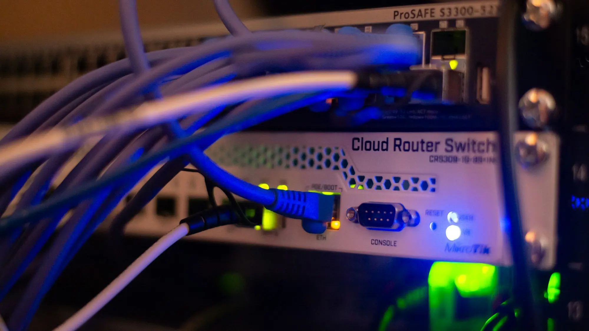 Close-up of a network switch with blue cables plugged into its ports.