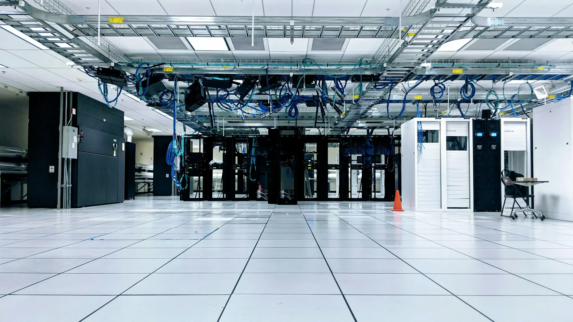 Rows of cabinets in a clean, brightly lit data hall.